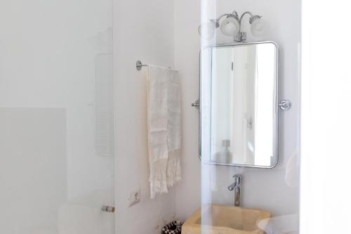 a bathroom with a sink and a mirror at B&B Don Alessandro in Surbo