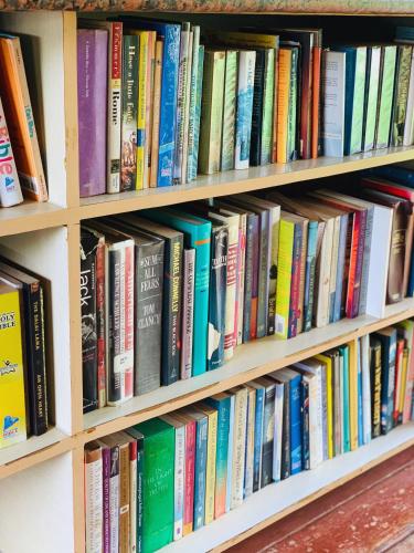 a book shelf filled with lots of books at Ciabel Hotel and Fitness Center in San Juan