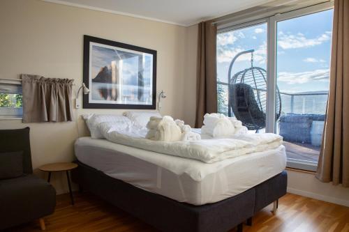 a bedroom with a bed with stuffed animals on it at Arctic Panorama in Tromsø