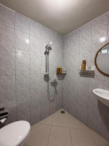 a bathroom with a shower and a sink at D'Labake Guest House in Sidemen