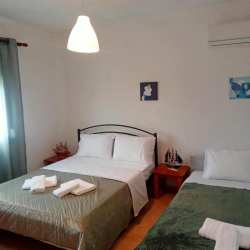 a bedroom with two beds with towels on it at Budget Family House in Mirodháton