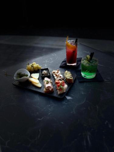 a tray of food and a drink on a table at Hotel Chiaro di Luna in Marina di Ascea