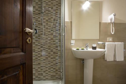 a bathroom with a sink and a shower at B&B Palazzo Tornabene in Catania