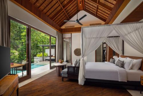 Ένα ή περισσότερα κρεβάτια σε δωμάτιο στο Impiana Private Villas Ubud