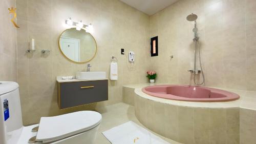 a bathroom with a tub and a toilet and a sink at Luxurious Al Danah 5BR Family Friendly Getaway in Abu Dhabi