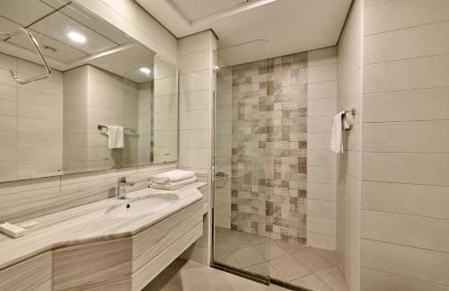 a bathroom with a sink and a shower at Grand Stay Holiday Homes Rental 2 in Dubai
