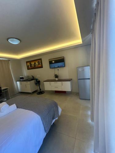 a bedroom with a bed and a tv in it at Immaculate,Alttrative &Modern 1 Noload shedding in Cape Town