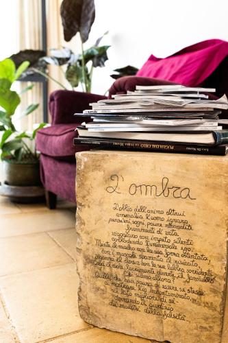 a pile of books sitting on top of a paper at B&B Don Alessandro in Surbo