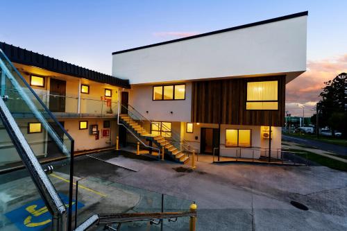 a building with a staircase in front of it at Takapuna International Motor Lodge in Auckland