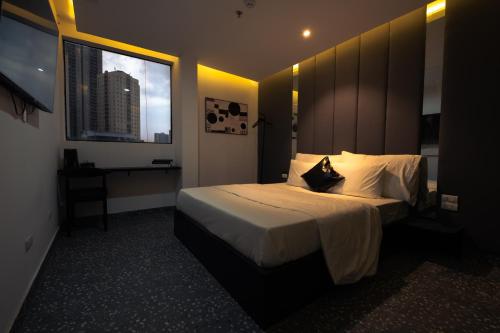 a hotel room with a bed and a window at Love in the Atlantis Hotel in Hanoi