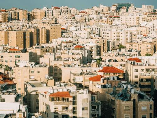 a view of a city with many buildings at Mövenpick Hotel Amman in Amman