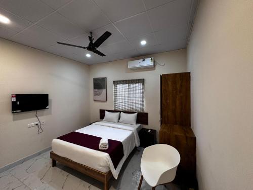 a bedroom with a bed and a ceiling fan at Urban Stay in Bengaluru