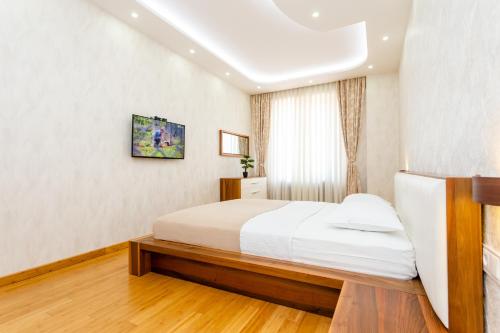 a bedroom with a white bed and a window at Hidden Gem In Tbilisi in Tbilisi City