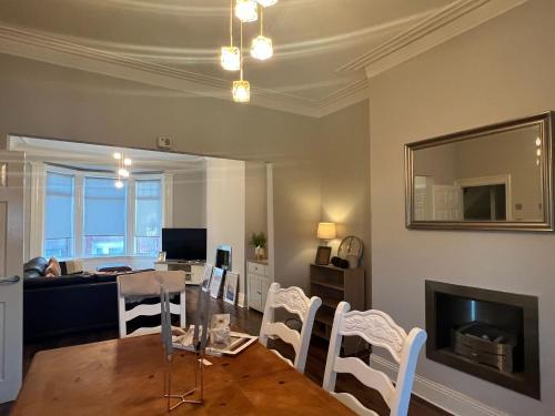 a living room with a table and a dining room at AA Exec Apartments in South Shields