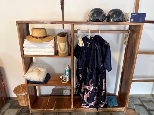 a shelf with clothes and hats on it at Dugong Bay - Làng Ẩm Thực & Sinh Thái - Eco & Seafood Village in Phu Quoc