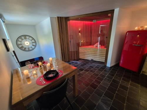 a dining room with a table and a red refrigerator at OCV Forest in Durbuy