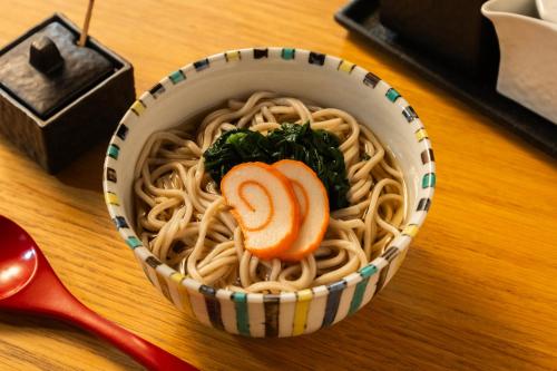 a bowl of noodles with a carrot on top at UAN kanazawa in Kanazawa