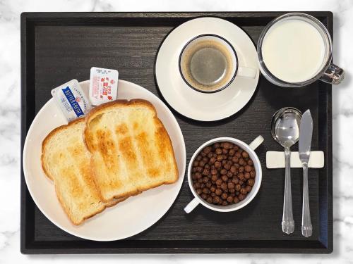 a tray with a plate of toast and a cup of coffee at Hotel Foret Premier Nampo in Busan
