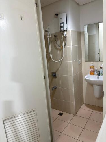 a bathroom with a shower and a sink at Urban haven Family&Barkada room in Manila