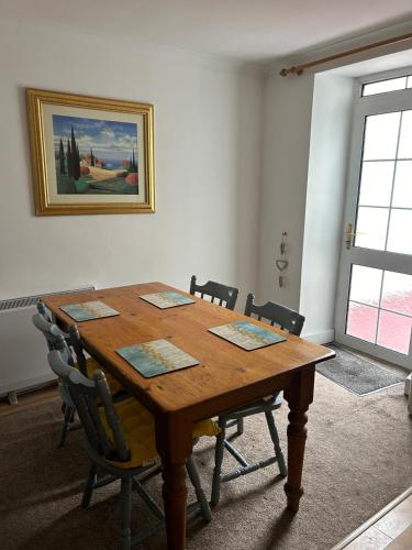 a room with a wooden table and chairs at Bantry Town in Bantry