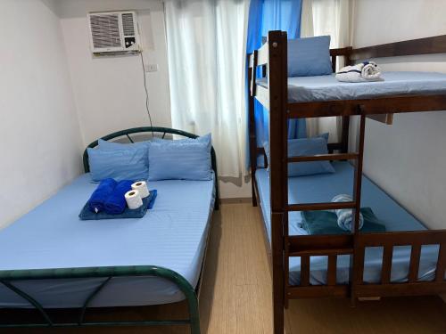a small room with two bunk beds and a ladder at Urban haven Family&Barkada room in Manila