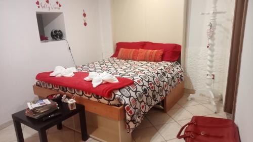 a small bedroom with a bed with towels on it at Sally's House in Venaria Reale