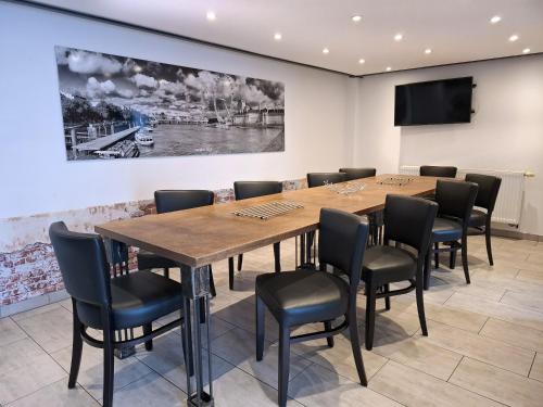 a conference room with a wooden table and chairs at Loft-Unterkunft in Sinsheim