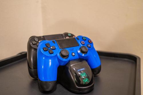 a blue video game controller sitting on top of a table at Serenity Luxury Smart Villas with Private Pool, Canggu in Dalung