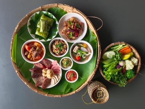 a plate of food on top of a green plate at The Namkhan, a Small Luxury Hotel of the World in Luang Prabang