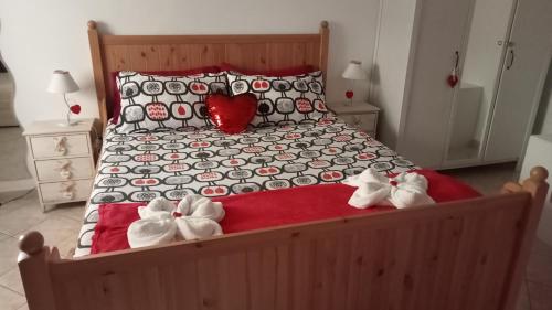a bed with two stuffed animals sitting on it at Sally's House in Venaria Reale