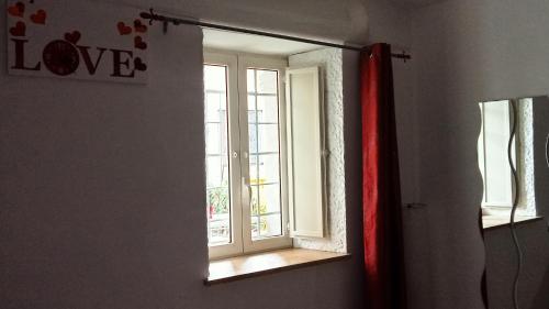a mirror in a room with a window at Sally's House in Venaria Reale