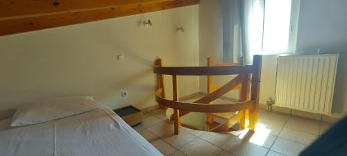 a small room with a bed and a wooden chair at Harmony 5 in Áyios Spirídhon