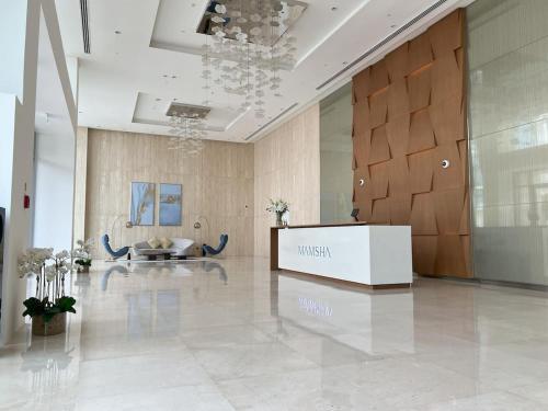 a lobby with a museum sign in the middle of a building at 2 BR Soul Beach Mamsha Sadiyaat - Partial Sea view in Abu Dhabi