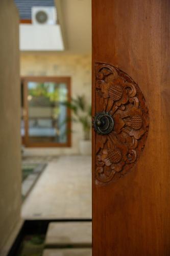 a wooden door with a door knob on it at Niva Sanctuary - Family Friendly 2BR Villa with private pool - Between Sanur & Ubud in Ketewel