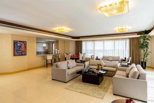 a large living room with couches and a table at The K Hotel in Manama