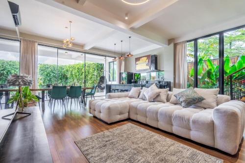 a living room with a couch and a dining room at Serenity Luxury Smart Villas with Private Pool, Canggu in Dalung