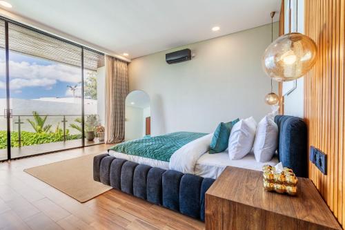 a bedroom with a bed and a view of the ocean at Serenity Luxury Smart Villas with Private Pool, Canggu in Dalung
