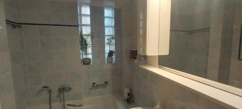 a bathroom with a tub and a sink and a mirror at Harmony 5 in Áyios Spirídhon