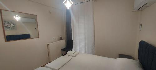 a small room with a white table and a mirror at Harmony 5 in Áyios Spirídhon