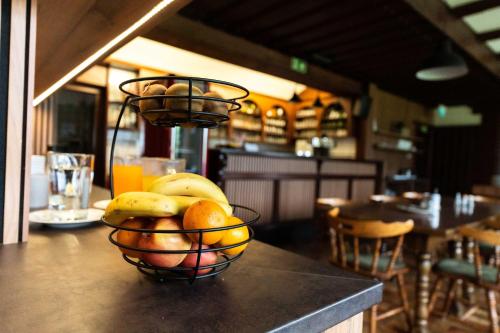 a basket of fruit on a counter in a restaurant at Pension Tilly in Niederöblarn