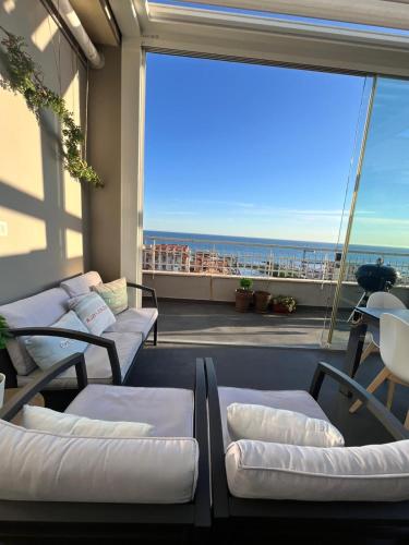 a balcony with couches and a view of the ocean at Terrazza sul mare in Ladispoli