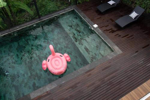a pink toy elephant in a swimming pool at Serenity Luxury Smart Villas with Private Pool, Canggu in Dalung