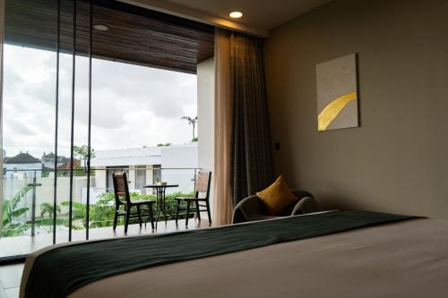 a bedroom with a bed and a balcony with a table at Serenity Luxury Smart Villas with Private Pool, Canggu in Dalung