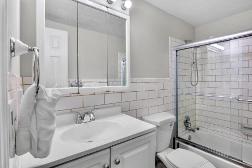 a bathroom with a sink and a toilet and a mirror at Gulf Haven in Anna Maria Island