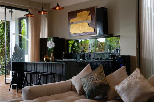 a living room with a couch and a kitchen at Serenity Luxury Smart Villas with Private Pool, Canggu in Dalung
