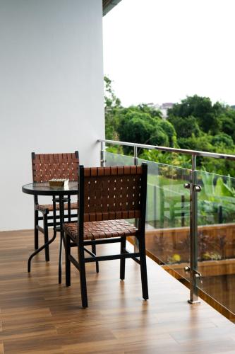 two chairs and a table on a balcony with a view at Serenity Luxury Smart Villas with Private Pool, Canggu in Dalung
