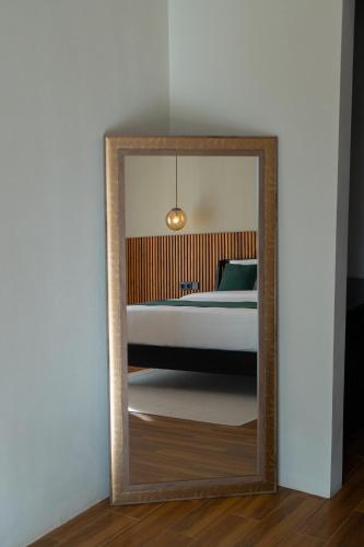 a mirror in front of a bedroom with a bed at Serenity Luxury Smart Villas with Private Pool, Canggu in Dalung