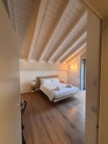 a bedroom with a bed and a wooden floor at Suite Belfuso in Cremona