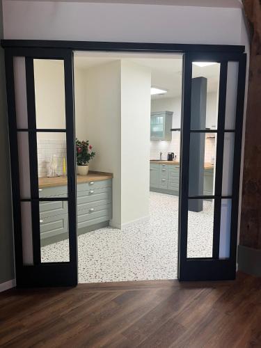a room with sliding glass doors in a kitchen at Schloms Hof in Waffensen