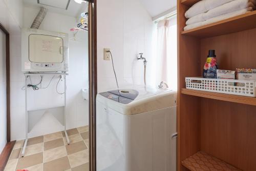 a bathroom with a sink and a washing machine at Wind Makiminato - Vacation STAY 73174v in Urasoe